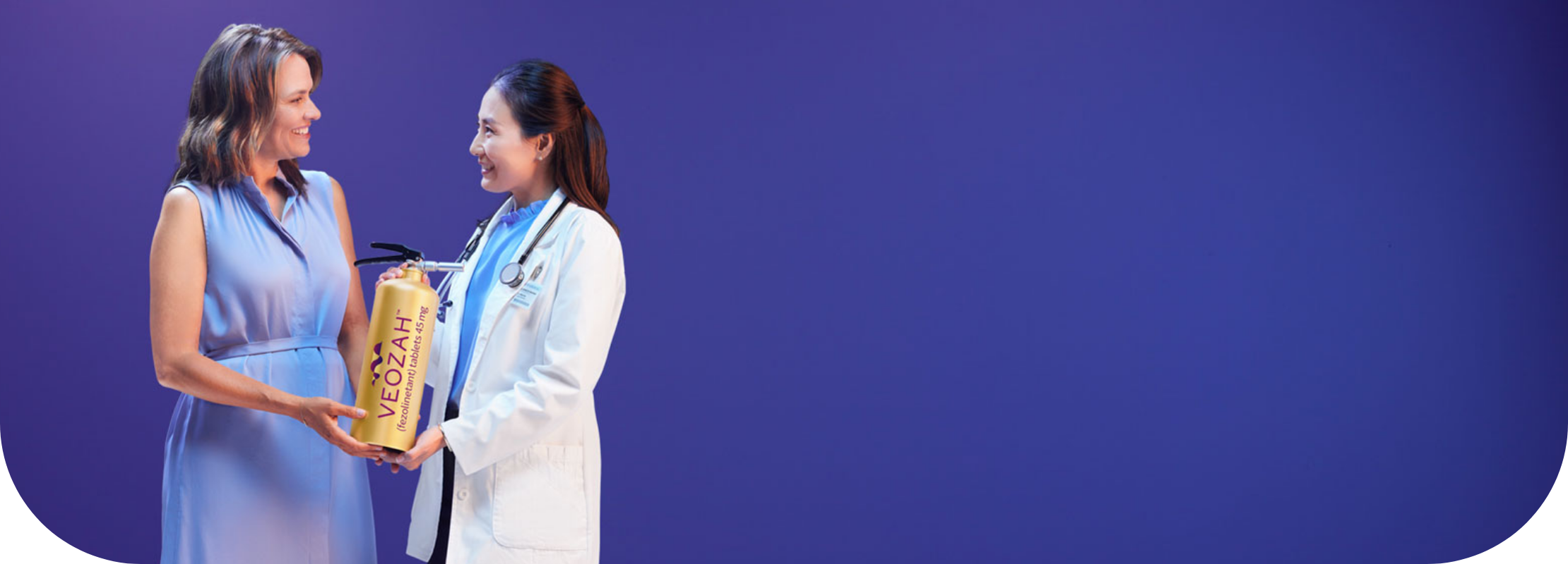 Woman and doctor holding VEOZAHTM (fezolinetant) logo fire extinguisher
