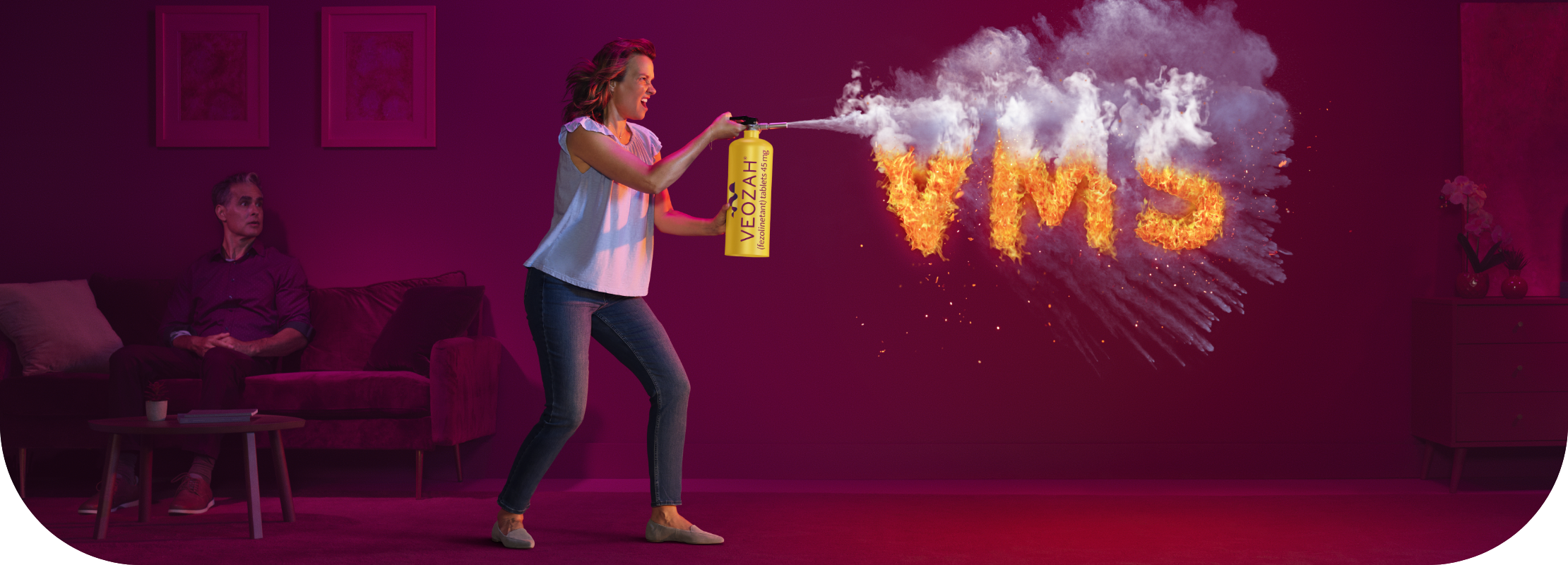 Woman spraying VEOZAH® (fezolinetant) logo fire extinguisher at VMS fire in living room with man sitting and watching